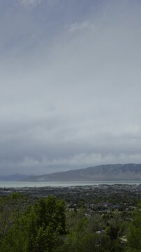 A vertical video timelapse of an entire day with changing weather, overlooking Utah Valley and Utah Lake, Cedar Hills, UT