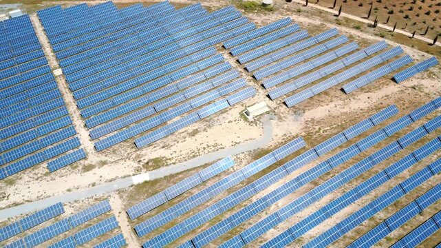 Aerial view flying over solar panels farm