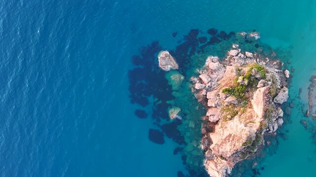 Aerial top down view of a rocky islet in Corfu
