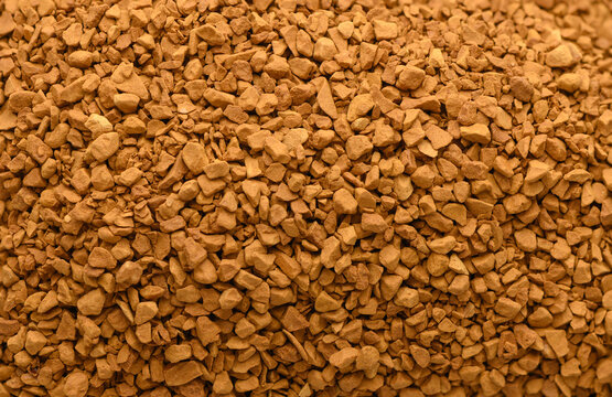 Instant coffee granules static, in unknown, with instant coffee granules, with coffee granules texture, from a top-down perspective, with brown, orange accents.