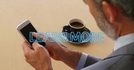 Senior businessman tapping smartphone, initiating neon-blue LEARN MORE overlay, navigating app © vectorfusionart