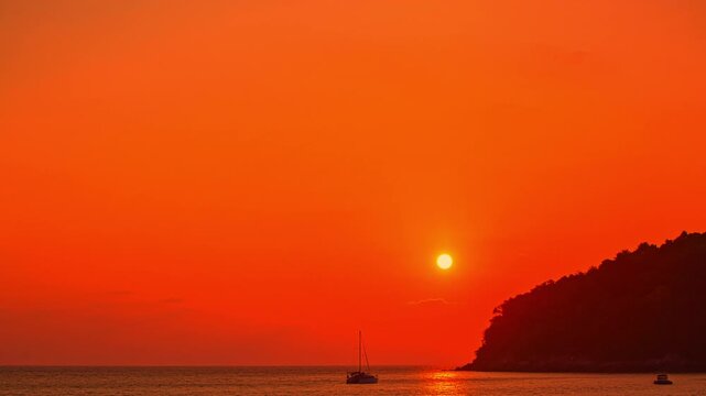 Time lapse A peaceful tropical comes alive with color as the sun sets, offering a perfect moment of serenity and beauty. Vibrant Colors of a Tropical Evening at Kala island Layan beach Phuket