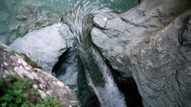 Mountain river with turquoise water flowing through the spectacular gorner gorge in zermatt, switzerland