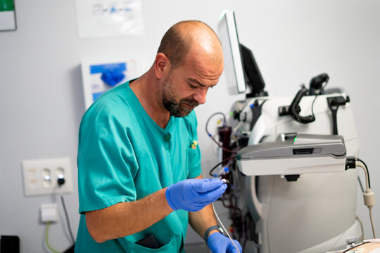 Medical professional preparing apheresis machine for treatment