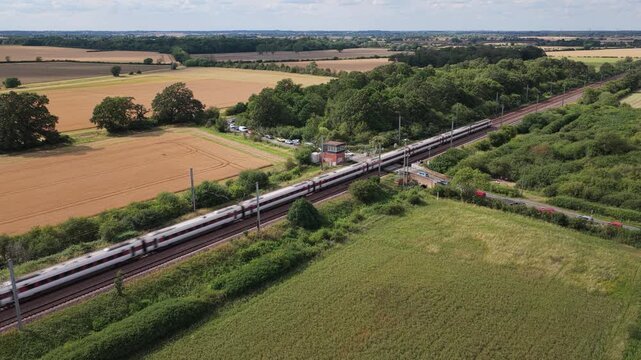 Azuma Train Passes Rural English Level Crossing