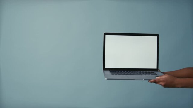 Hands Holding Laptop with Blank Screen for Mockup on Blue