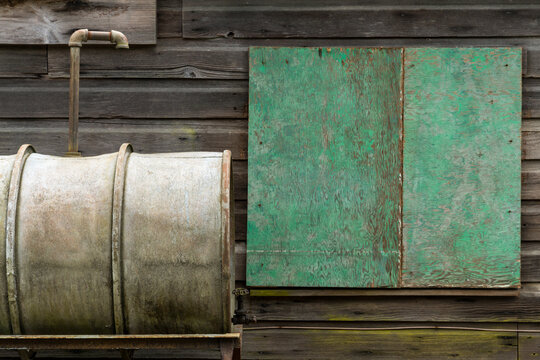 Canada, BC, Richmond.  Rustic detail of steel storage tank and weathered siding.