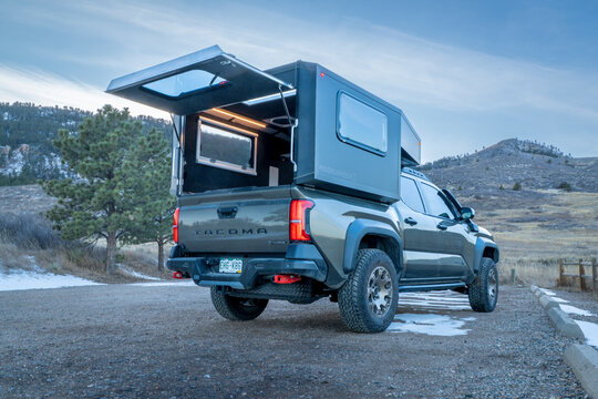 Fort Collins, CO, USA - January 21, 2026: Moonlander camper by Radica on Toyota Tacoma Trailhunter hybrid truck in Lory State Park, Colorado.