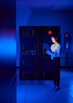 Asian Woman Managing Cloud Infrastructure in Data Center