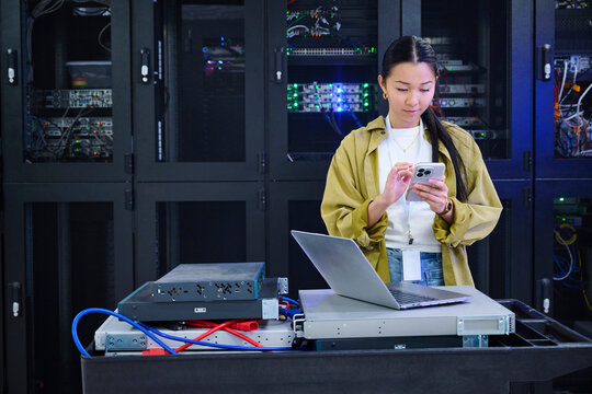 Asian Woman Using phone in Data Center