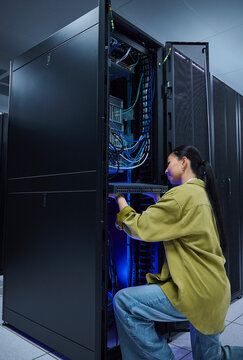 Asian Woman Managing Cloud Infrastructure in Data Center