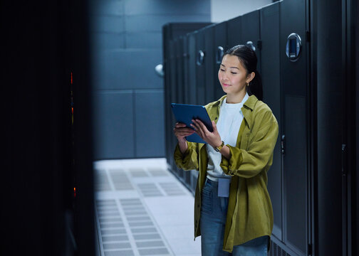 Female Technology Engineer Using Digital Tablet in Data Center