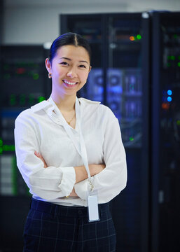 Female Technology Specialist Standing in Server Room