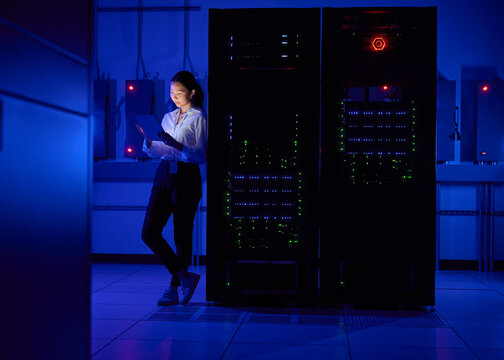 Asian Female Engineer Working in Modern Data Center