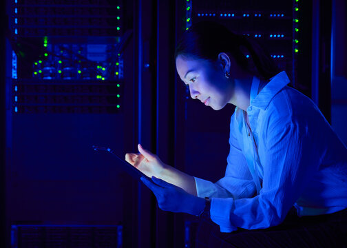 Asian Female Cybersecurity Professional Working in Data Center