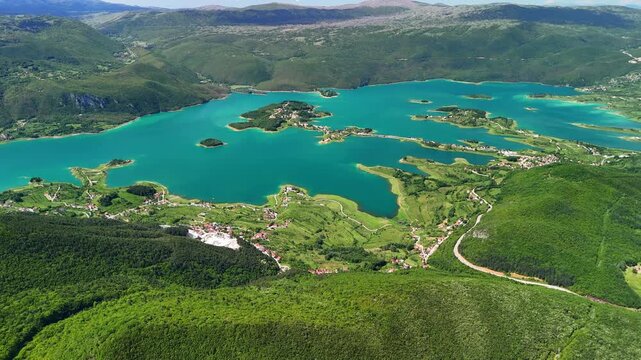 Aerial view of Rama Lake, a beautiful and breathtaking lake with many small islands. It is truly a stunning sight, surrounded by lush green mountain slopes. Bosnia and Herzegovina.	