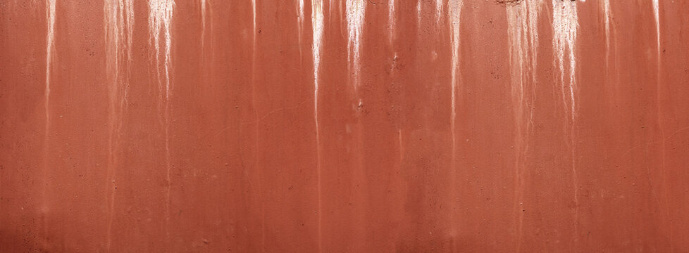 Terracotta textured wall showing white dripping streaks