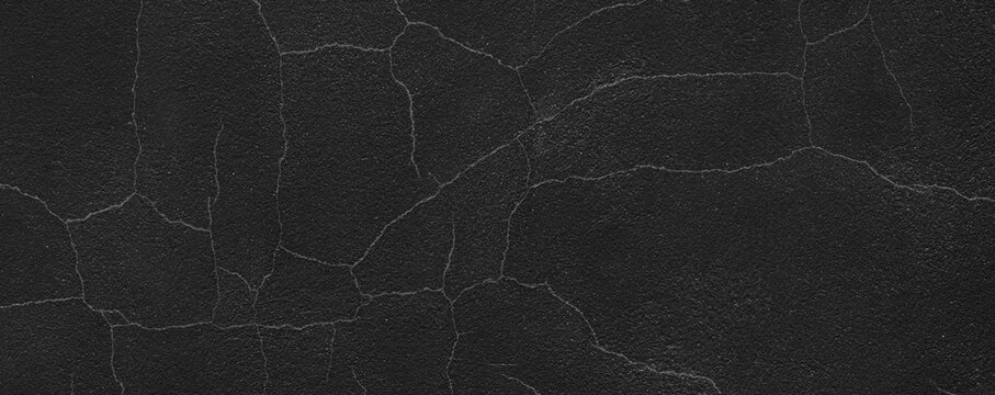 Dark cracked wall texture creating abstract grungy background