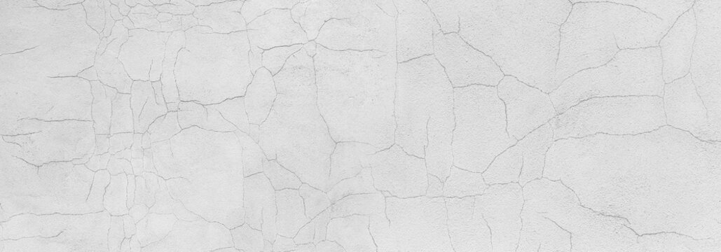 White cracked wall texture showing damaged plaster surface