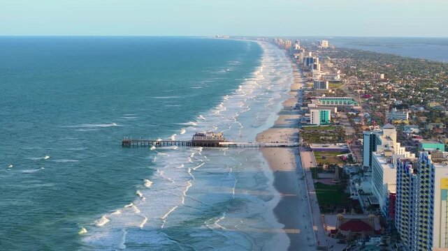 Daytona Beach city, Florida. Main Street Pier with surrounding luxury hotels and condos as part of the city's coastal tourist infrastructure.