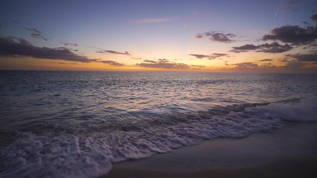 Exotic coastal landscape with vivid sunset tones, flowing waves and expansive sky, capturing the essence of paradise and seaside tranquility.
