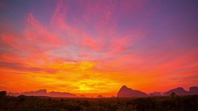 Time lapse Amazing light of nature cloudscape sky above Samed Nang Chee islands in Phang Nga.
Imagine a fantasy bright red sky at sunrise.
tropical landscape background.fantasy red clouds in sunrise
