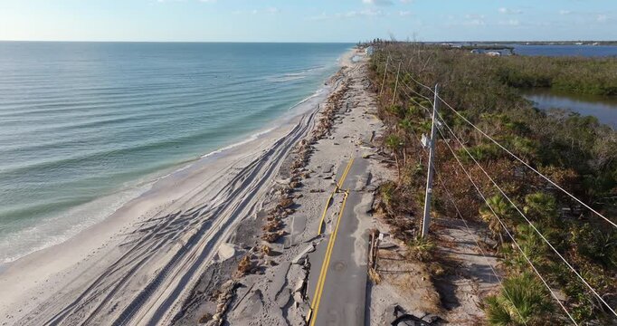 Hurricane storm surge destroyed waterfront road on ocean shore in Florida. Severe damage to transportation infrastructure