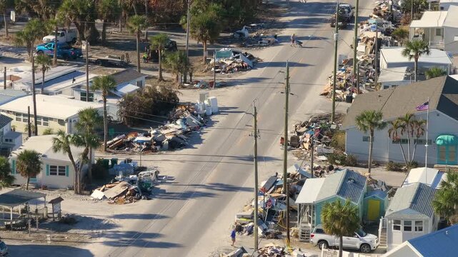Piles of debris on street side after hurricane Milton on Manasota key road in Florida. Trash from severely damaged houses after storm surge. Consequences of natural disaster.