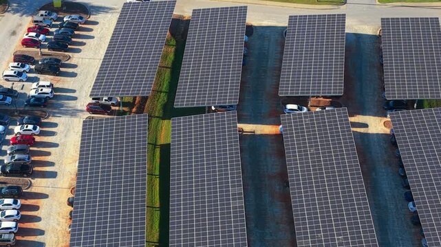 Sustainable power production integrated in urban infrastructure. Photovoltaic solar panels over car parking place for generation of renewable energy.