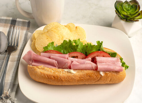 ham sub  with served with a side of chips