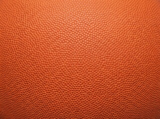 Obraz premium Close-up view of the textured surface of an orange basketball, showing its characteristic pebbled grip pattern and vibrant color.
