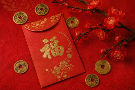 Red lucky envelope with Chinese coins and plum blossoms on a festive background. Perfect for Lunar New Year ads, greeting cards, banners, and social media