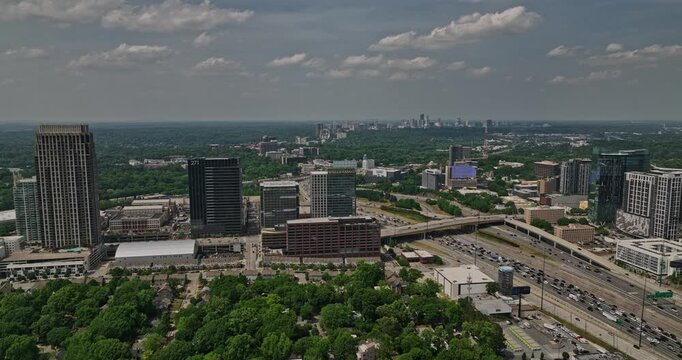 Atlanta Georgia Aerial v828 flyover Midtown overlooking at Atlantic Station retail complex and busy Interstate 85 highway traffics with Buckhead cityscape views - Shot with Mavic 3 Cine - May 2022