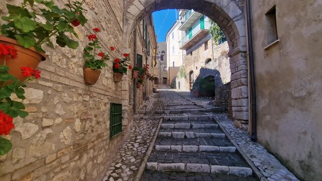 Walking POV Ancient Casperia Medieval Borgo Italy Handheld Footage Narrow Cobblestone Streets Charming Stone Arches Geranium Flowers in Pots Authentic Hidden Gem Cinematic Travel Vlog 4k