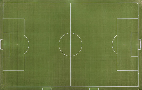 Aerial view of a soccer field with white markings on green grass in Diepenbeek, Belgium.
