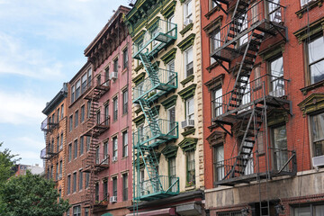 New York City, colorful old apartment buildings with ornate roof cornice and external fire escape © Spiroview Inc.