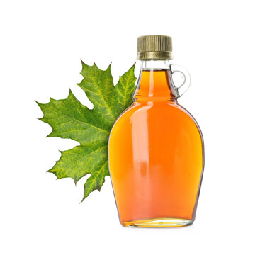 Maple syrup in bottle and leaf isolated on white