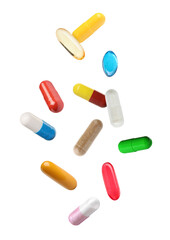 Fototapeta na wymiar Many various pills falling against transparent background