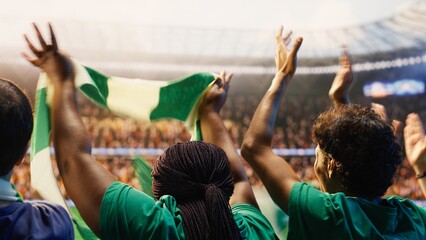 Fototapeta premium Football fans clapping in packed stadium, building energetic match day atmosphere for football fan and match day concepts.