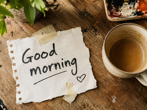 Good morning note Tate to a table next to a cup