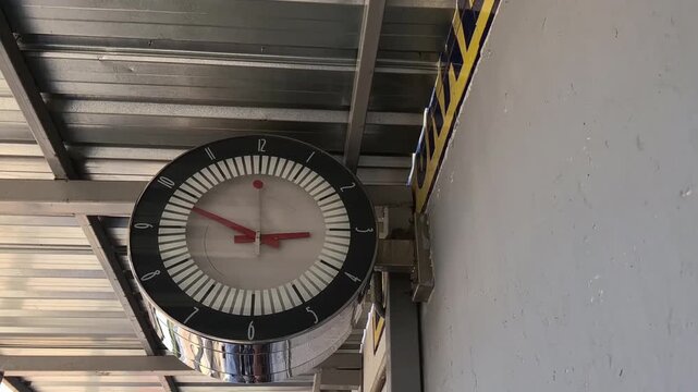 Classic or digital clock at a high-speed train station, indicating departure or arrival time.