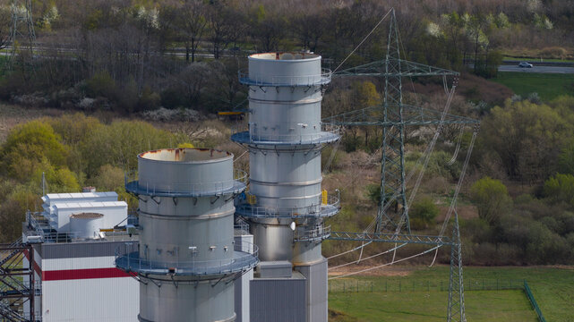 Aerial view of Trianel Gaskraftwerk Hamm power plant with industrial chimneys and high-voltage power lines in the surrounding landscape, Hamm, Nordrhein-Westfalen, Germany.