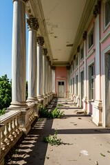 Fototapeta premium Marble columns line balcony of abandoned pink palace under bright sun. Overgrown plants sprout from cracked floor. Forgotten grandeur, decaying estate, history whispers on windy days.