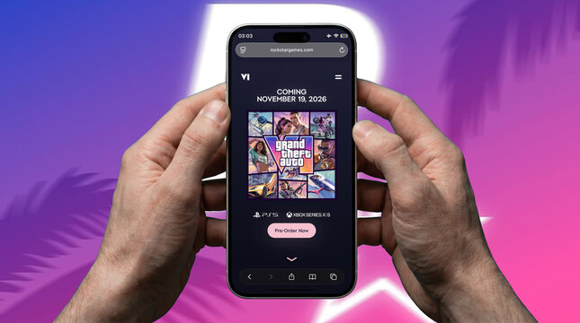 Grand Theft Auto VI Rockstar Games website on iPhone showing November 19 2026 release date pre-order page held with both hands