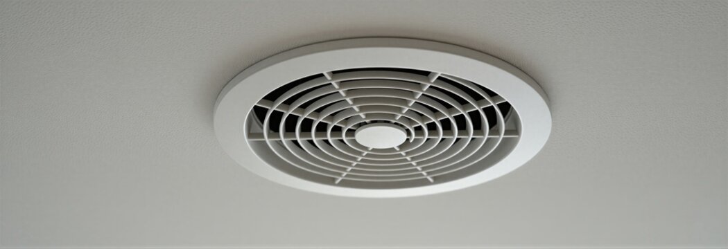 White round ceiling vent for air conditioning system. Modern HVAC unit supplies fresh air flow for climate control inside homes or offices. Minimalist fixture for airflow.