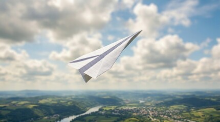 Fototapeta premium Paper airplane flying over rural landscape with soft clouds and distant river for playful travel poster or banner background design