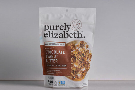 bag of Purely Elizabeth brand gluten-free chocolate peanut butter ancient grain granola on a white background with copy space