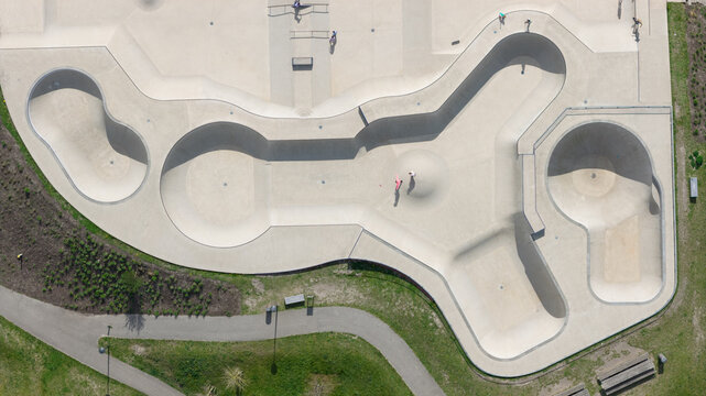 Aerial view of Zeeburgereiland Skate Park featuring concrete bowls and ramps with skaters practicing in Amsterdam, Noord-Holland, Netherlands.