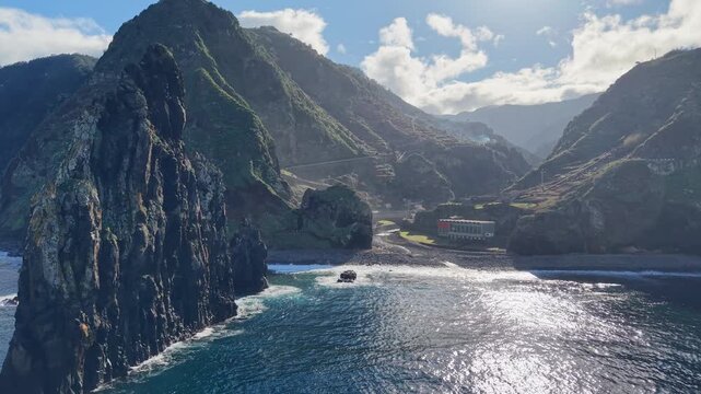 Aerial drone fly toward the iconic volcanic sea stack at Ribeira da Janela, Madeira, Portugal