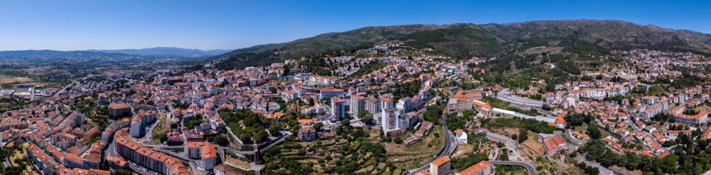 Aerial view of the city of Covilha nestled in the mountainous landscape of the Castelo Branco District, Portugal.